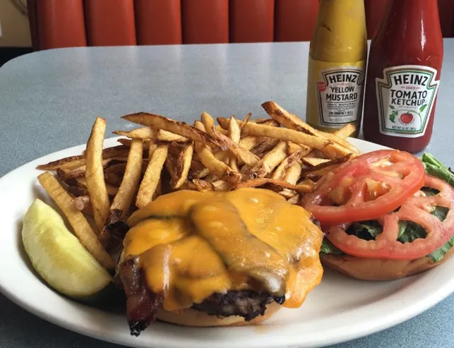 Cheeseburger with fresh-cut fries and tomato at The Uptowner Café